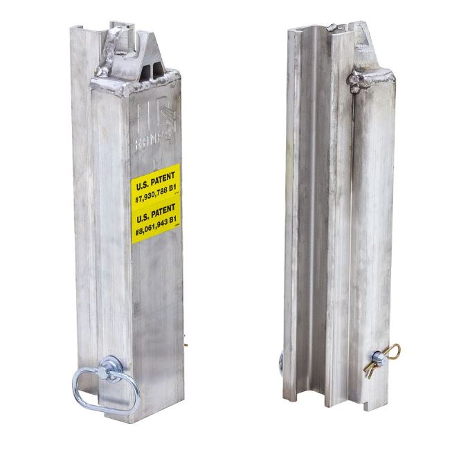 Left-side aluminum load leveler stake measuring 4-1/8 inches long, 4-1/8 inches wide, and 18-1/4 inches high; weighs 10 lbs and fits 3/8-inch chain for securing step deck trailer ramps.