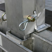 Aluminum load leveler measuring 5 inches long, 100-7/8 inches wide, and 18 inches high; 20,000-pound capacity, adjustable stake pocket post, suitable for 18-inch drop step deck trailers.